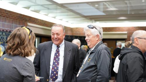 a photo of alumni connecting at the tailgate